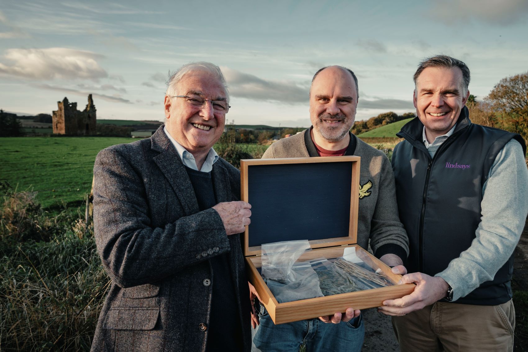 Angelo being offered a cerimonial gift from the former owner, James Brown, including a bit of soil, crops and an ancient coin, in the presence of Nicholas Howie of Lindsays, the Scottish law firm that took care, with Lockharts Law, of Baltersan sale.